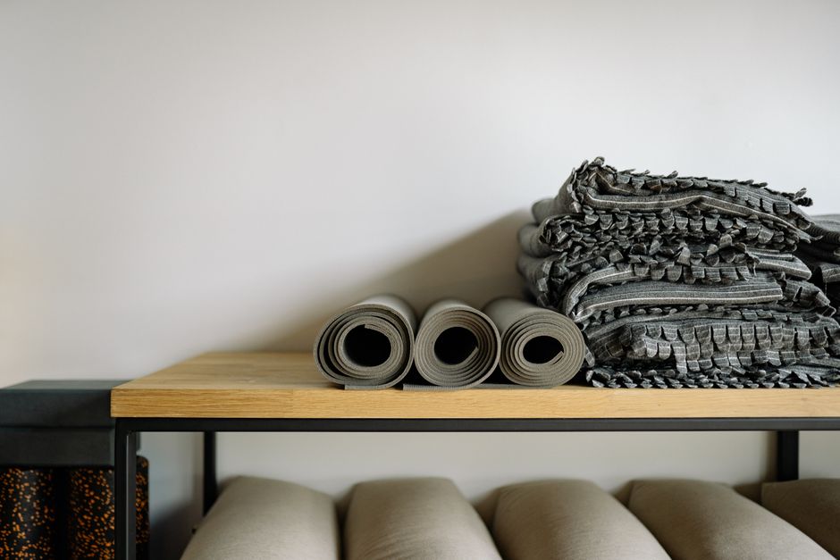 Rolled mats and folded blankets on the studio prop shelf